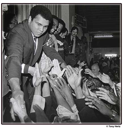 Muhammad Ali greets inmates at a California Mens Colony Prison.